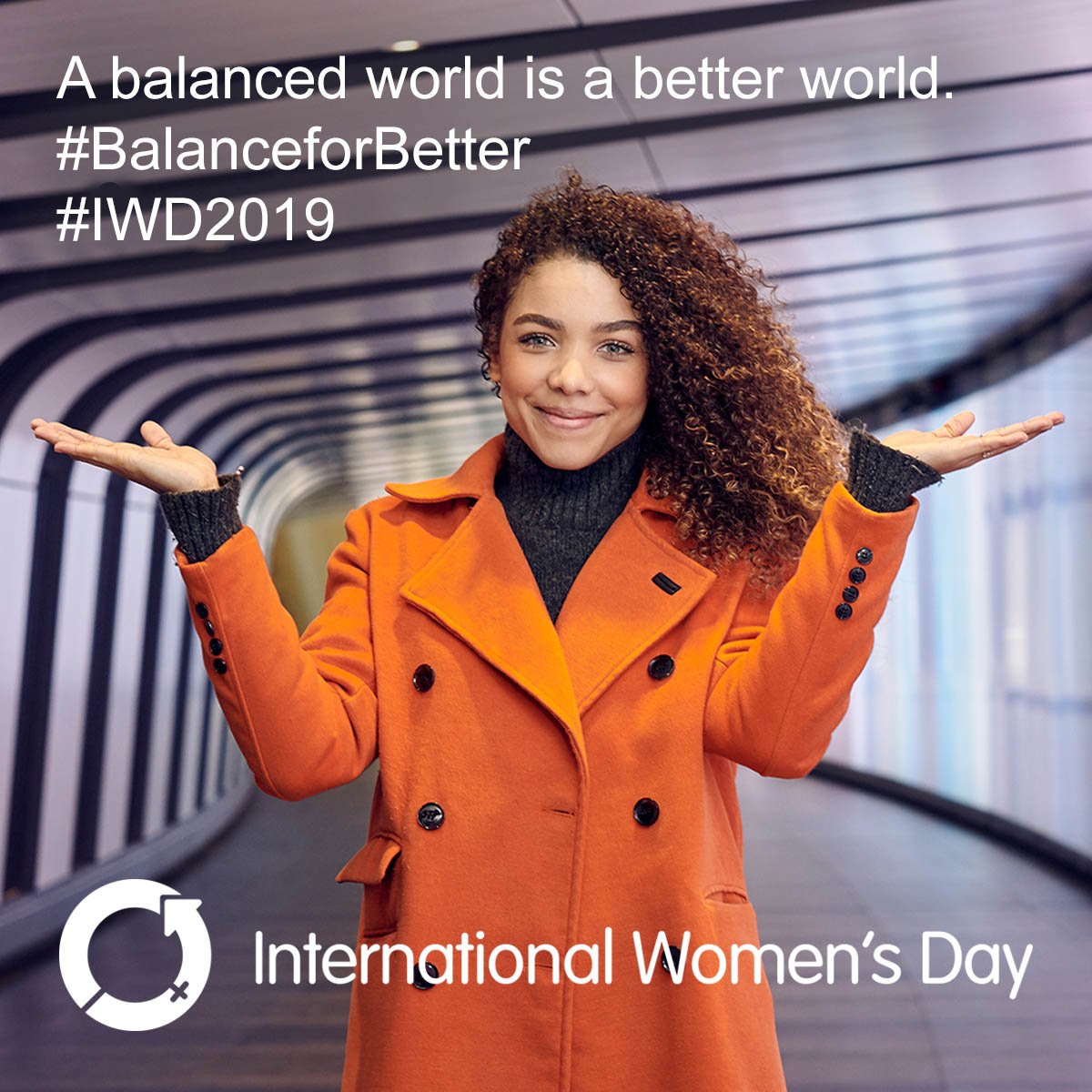 Women smiling with her hands raised. A balance world is a better world #BalanceforBetter #IWD2019