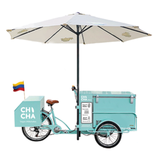 An image of the Chicha cart - which is a light blue teal colour - and has an umbrella on the top.