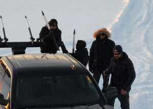 The AirShare team working outside in cold weather with drone disabling missile prototypes. 