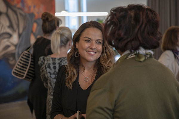 two people conversing at an event held by Invest Ottawa